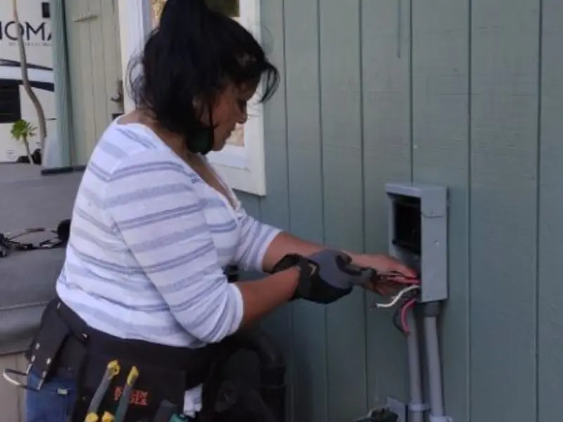 Licensed electrician wiring an exterior subpanel in Forest Park